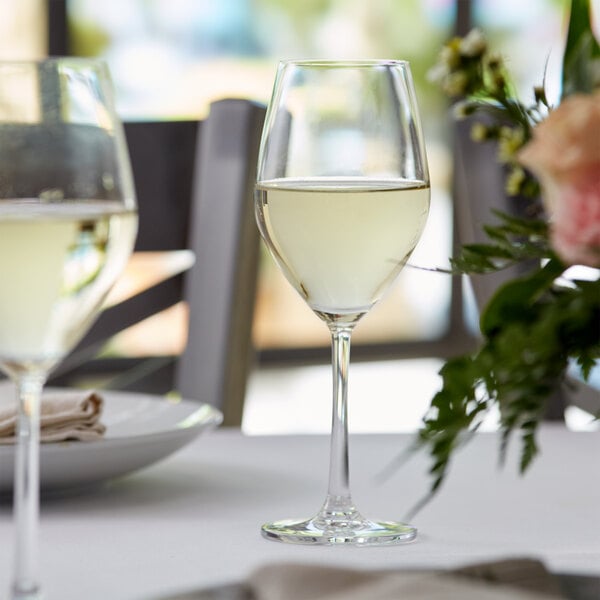 White wine glass filled with chardonnay wine on an elegant table