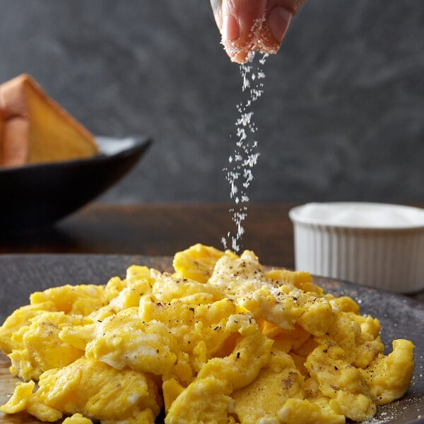 Sprinkling salt onto scrambled eggs