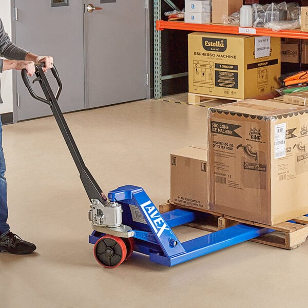 worker using a pallet jack to move pallet of boxes