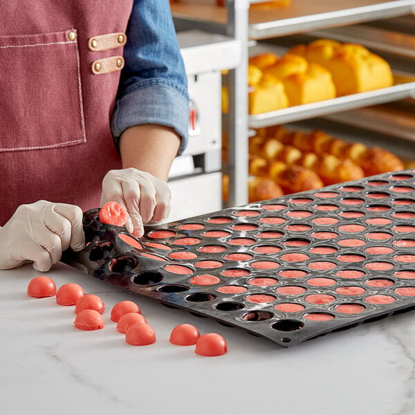 Baker popping candies out of a Silicone Mold