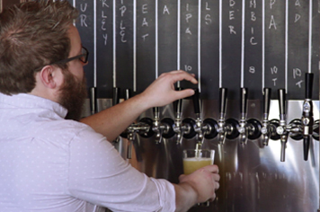 bartender pouring a draft beer