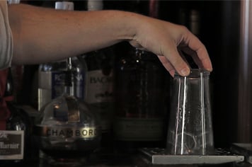bartender rinsing a beer glass