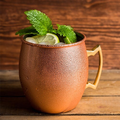Lined copper mug holding a moscow mule inside