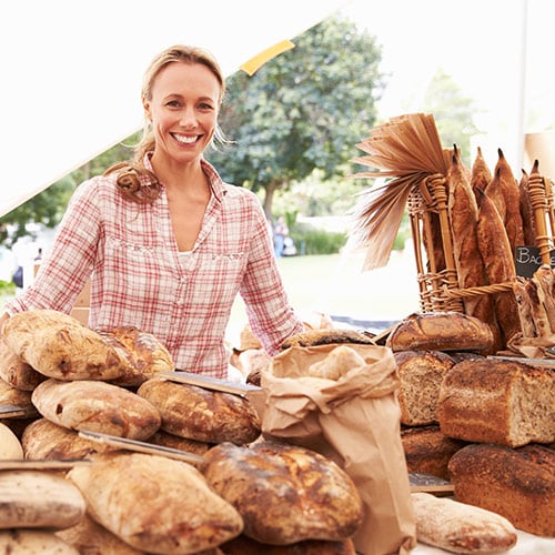 home baker selling bread at farmers market