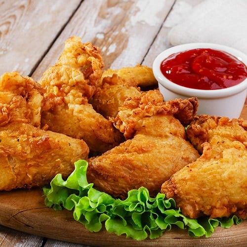 fried chicken on wooding cutting board with dipping sauce
