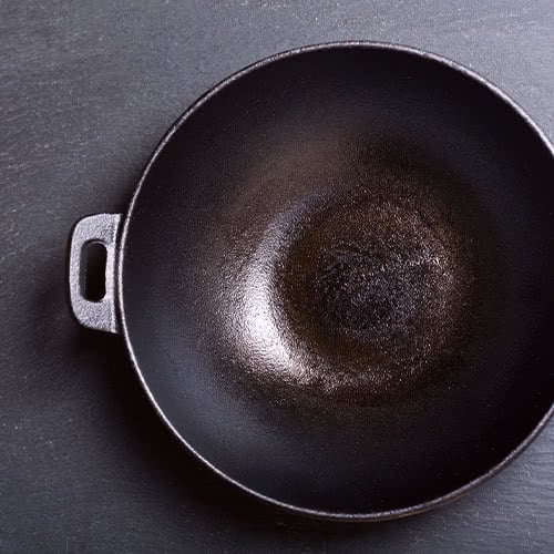 Cast iron wok with handles