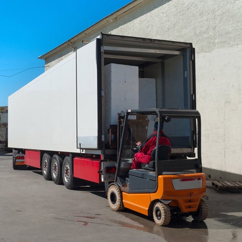 Unloading common carrier shipments from a truck with a forklift