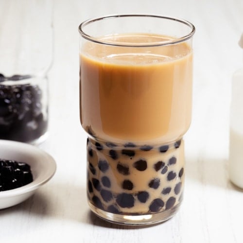 Bubble tea ingredients, glass of bubble tea, and boba pearls