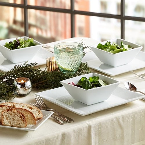 meal courses on table featuring plates of food, salad bowls, and silverware