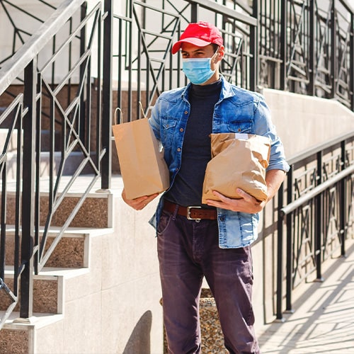 A man carrying delivery bags.
