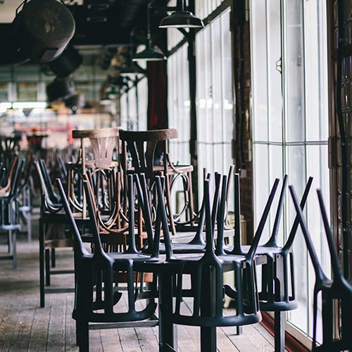 chairs and tables stacked in closed restaurant
