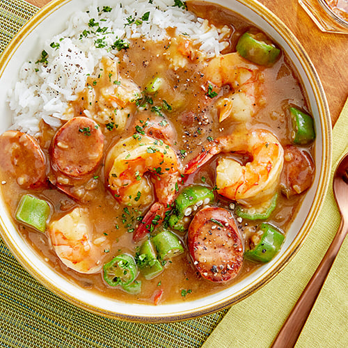 shrimp gumbo in bowl on yellow placemat