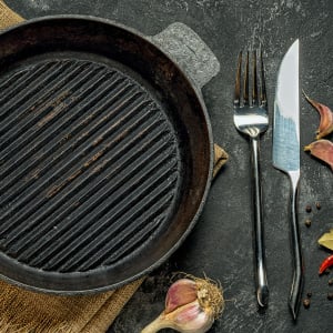 older cast iron grill pan and utensils