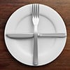 knife and fork in a cross position on a plate