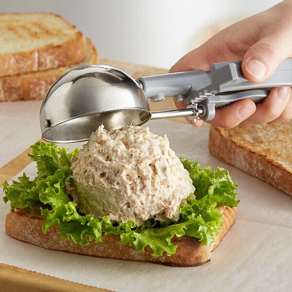 Gray squeeze handle disher portioning tuna onto a sandwich