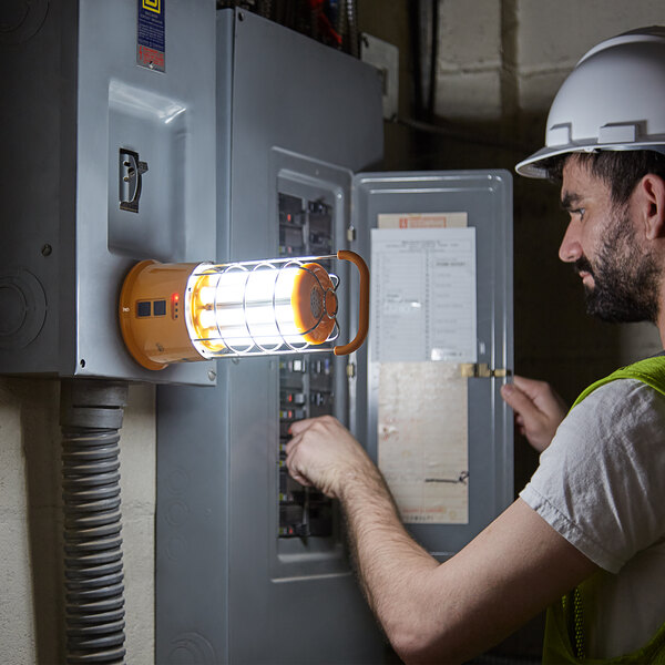 Electrician working next to a magnet mounted work light