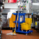 Lavex Janitorial Blue Cleaning / Janitor Cart Kit with Yellow Mop Bucket, Wet Floor Sign, Mop, and Caddy Main Thumbnail 1