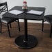 Lancaster Table & Seating Standard Height Table with 30" x 30" Reversible Cherry / Black Table Top and Round Base Plate Main Thumbnail 1