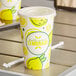 Carnival King 16 oz. Poly Paper Lemonade Cup and Flat Straw Slot Lid - 100/Pack Main Thumbnail 1