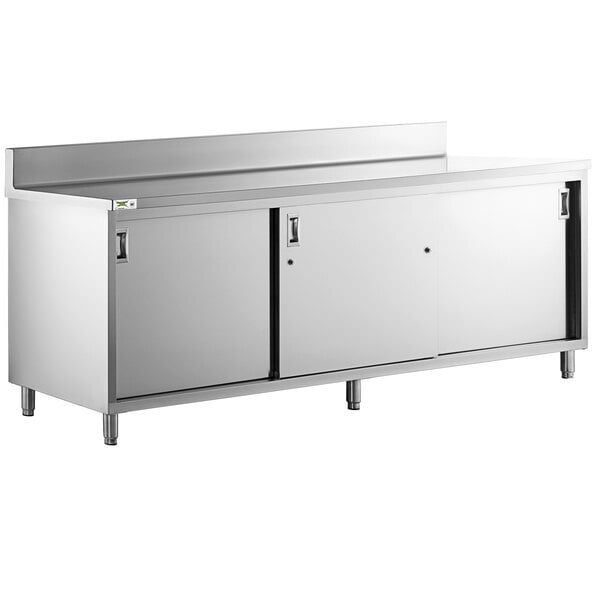 Scratch and Dent Regency 24" x 96" 16 Gauge Type 304 Stainless Steel Enclosed Base Sliding Door Table with Adjustable Midshelf and 6" Backsplash