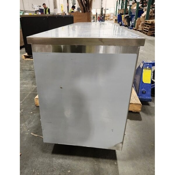 Scratch and Dent Regency 24" x 96" 16 Gauge Type 304 Stainless Steel Enclosed Base Table with Sliding Doors and Adjustable Midshelf