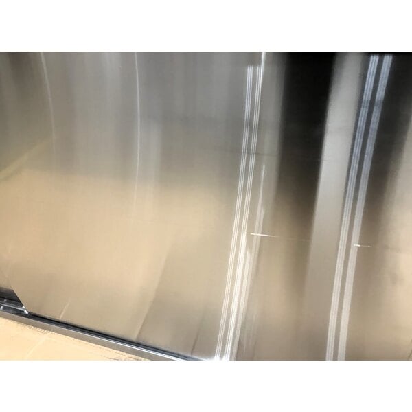 Scratch and Dent Regency 24" x 96" 16 Gauge Type 304 Stainless Steel Enclosed Base Sliding Door Table with Adjustable Midshelf and 6" Backsplash