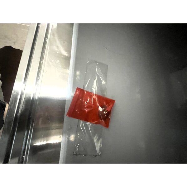 Scratch and Dent Regency 30" x 60" 16 Gauge Type 304 Stainless Steel Enclosed Base Sliding Door Table with Adjustable Midshelf and 6" Backsplash