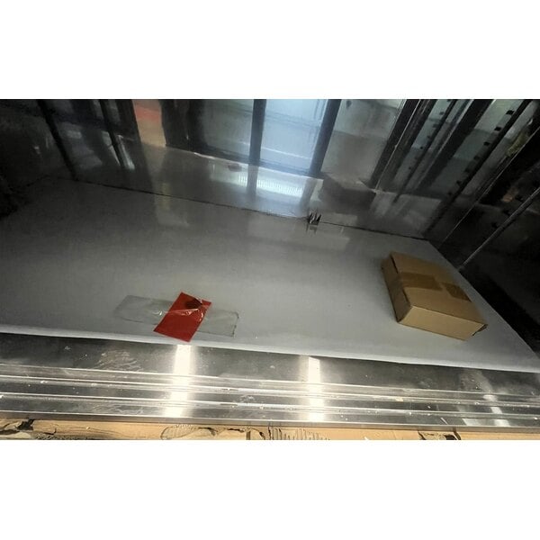 Scratch and Dent Regency 30" x 60" 16 Gauge Type 304 Stainless Steel Enclosed Base Sliding Door Table with Adjustable Midshelf and 6" Backsplash