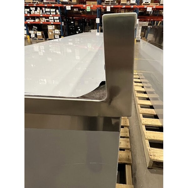 Scratch and Dent Regency 24" x 96" 16 Gauge Type 304 Stainless Steel Enclosed Base Sliding Door Table with Adjustable Midshelf and 6" Backsplash