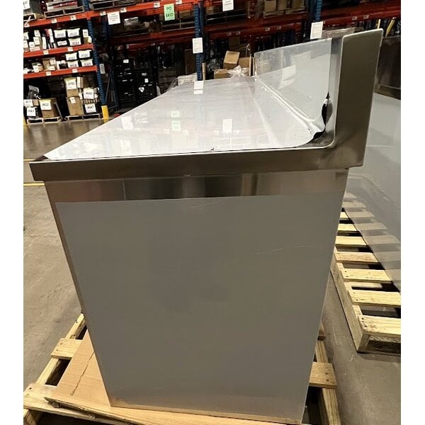 Scratch and Dent Regency 24" x 96" 16 Gauge Type 304 Stainless Steel Enclosed Base Sliding Door Table with Adjustable Midshelf and 6" Backsplash