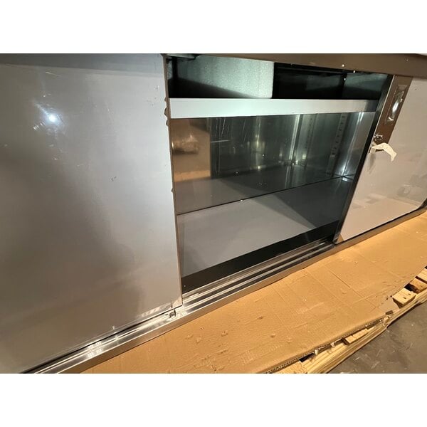 Scratch and Dent Regency 24" x 96" 16 Gauge Type 304 Stainless Steel Enclosed Base Sliding Door Table with Adjustable Midshelf and 6" Backsplash