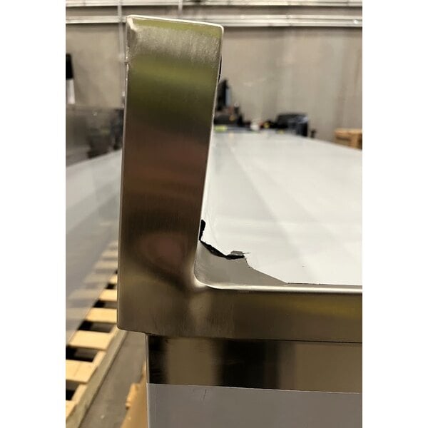 Scratch and Dent Regency 24" x 96" 16 Gauge Type 304 Stainless Steel Enclosed Base Sliding Door Table with Adjustable Midshelf and 6" Backsplash