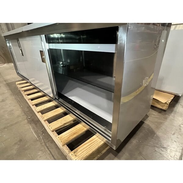 Scratch and Dent Regency 24" x 96" 16 Gauge Type 304 Stainless Steel Enclosed Base Sliding Door Table with Adjustable Midshelf and 6" Backsplash