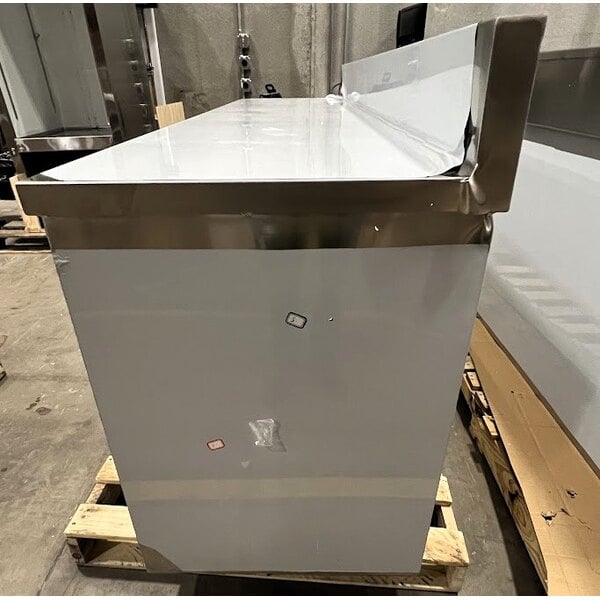 Scratch and Dent Regency 24" x 96" 16 Gauge Type 304 Stainless Steel Enclosed Base Sliding Door Table with Adjustable Midshelf and 6" Backsplash