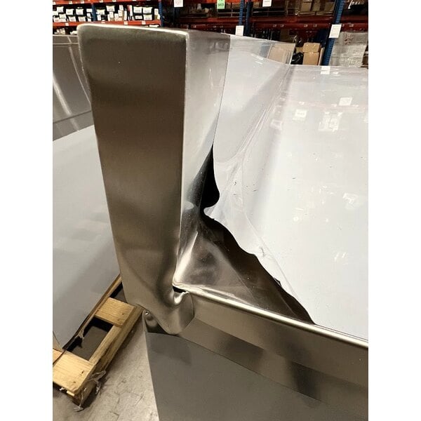 Scratch and Dent Regency 24" x 96" 16 Gauge Type 304 Stainless Steel Enclosed Base Sliding Door Table with Adjustable Midshelf and 6" Backsplash