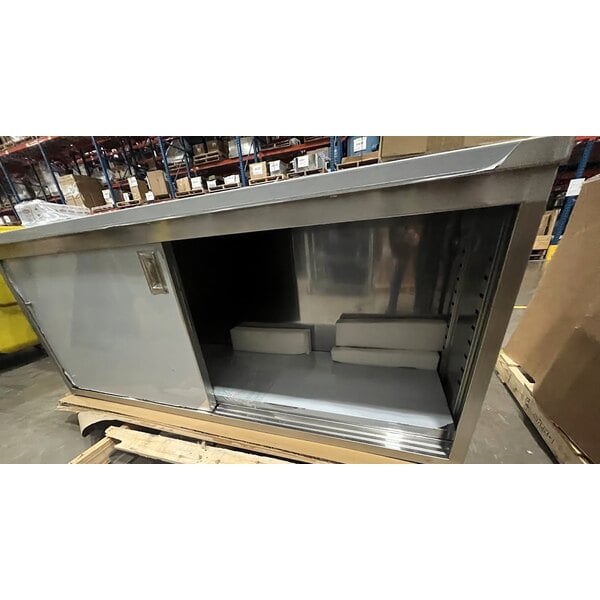 Scratch and Dent Regency C-2472-316 24" x 72" 16 Gauge Type 304 Stainless Steel Enclosed Base Table with Sliding Doors and Adjustable Midshelf
