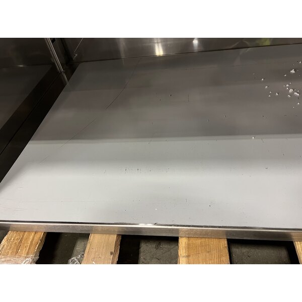 Scratch and Dent Regency 24" x 96" 16 Gauge Type 304 Stainless Steel Enclosed Base Table with Sliding Doors and Adjustable Midshelf