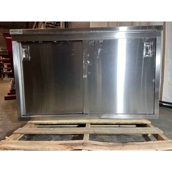 Scratch and Dent Regency 24" x 48" 16 Gauge Type 304 Stainless Steel Enclosed Base Table with Sliding Doors and Adjustable Midshelf