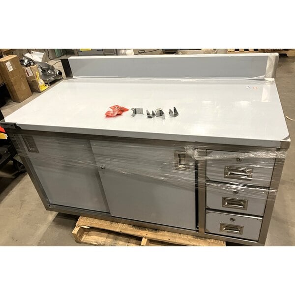 Scratch and Dent Regency 30" x 60" 16 Gauge Type 304 Stainless Steel Enclosed Base Sliding Door Table with Drawers and 6" Backsplash