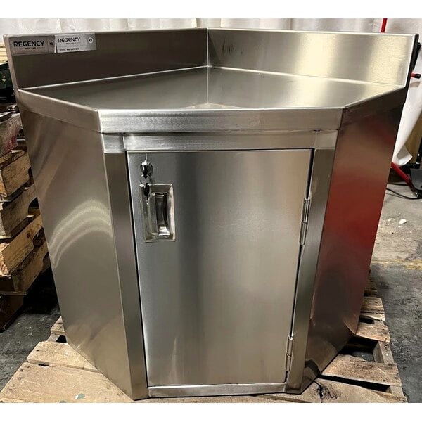 Scratch and Dent Regency Spec Line 24" x 24" 14-Gauge Stainless Steel Corner Work Table with Hinged Door and Lock