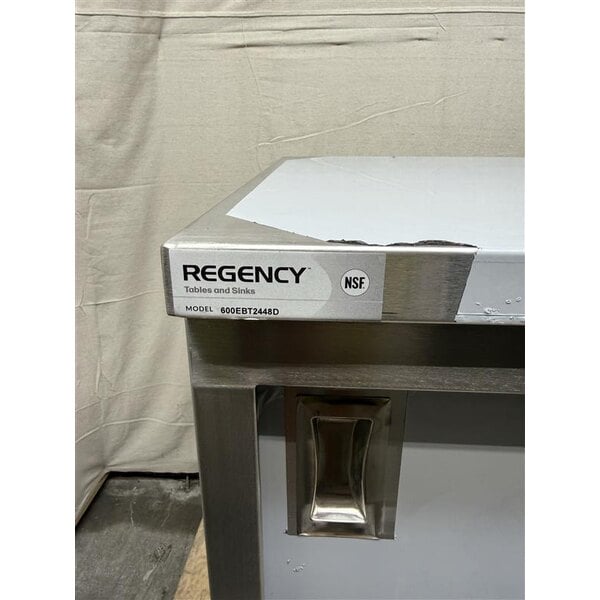 Scratch and Dent Regency 24" x 48" 16 Gauge Type 304 Stainless Steel Enclosed Base Table with Sliding Doors and Adjustable Midshelf