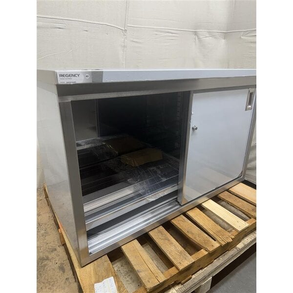 Scratch and Dent Regency 24" x 48" 16 Gauge Type 304 Stainless Steel Enclosed Base Table with Sliding Doors and Adjustable Midshelf