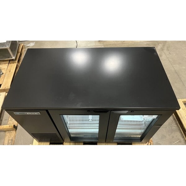 Scratch and Dent True TBB24-48-2G-Z1-BST-B-1 48 1/8" Black Underbar Glass Door Narrow Back Bar Refrigerator with Black Underbar Sub Top and LED Lighting