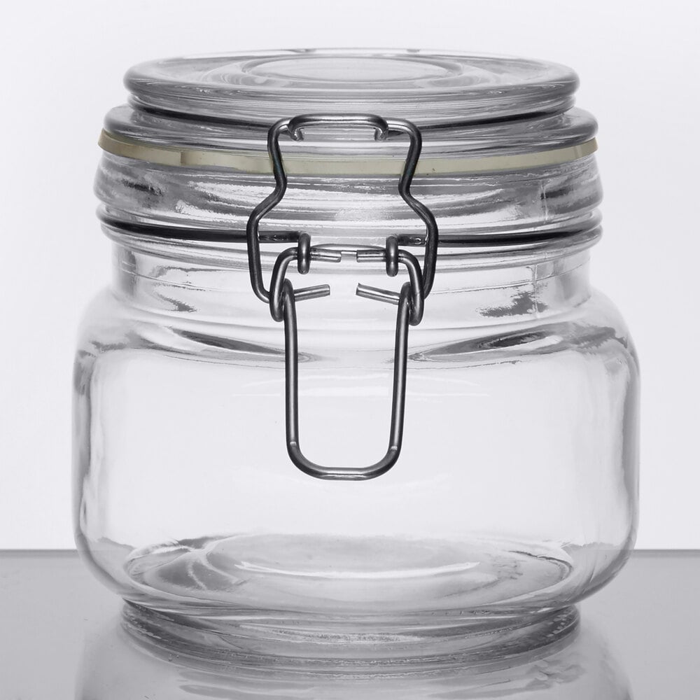 Clear glass jar with air-tight clamp and metal latch on a tabletop