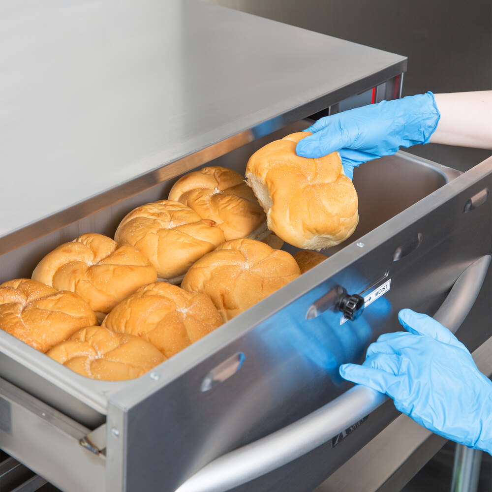placing rolls into warming drawer