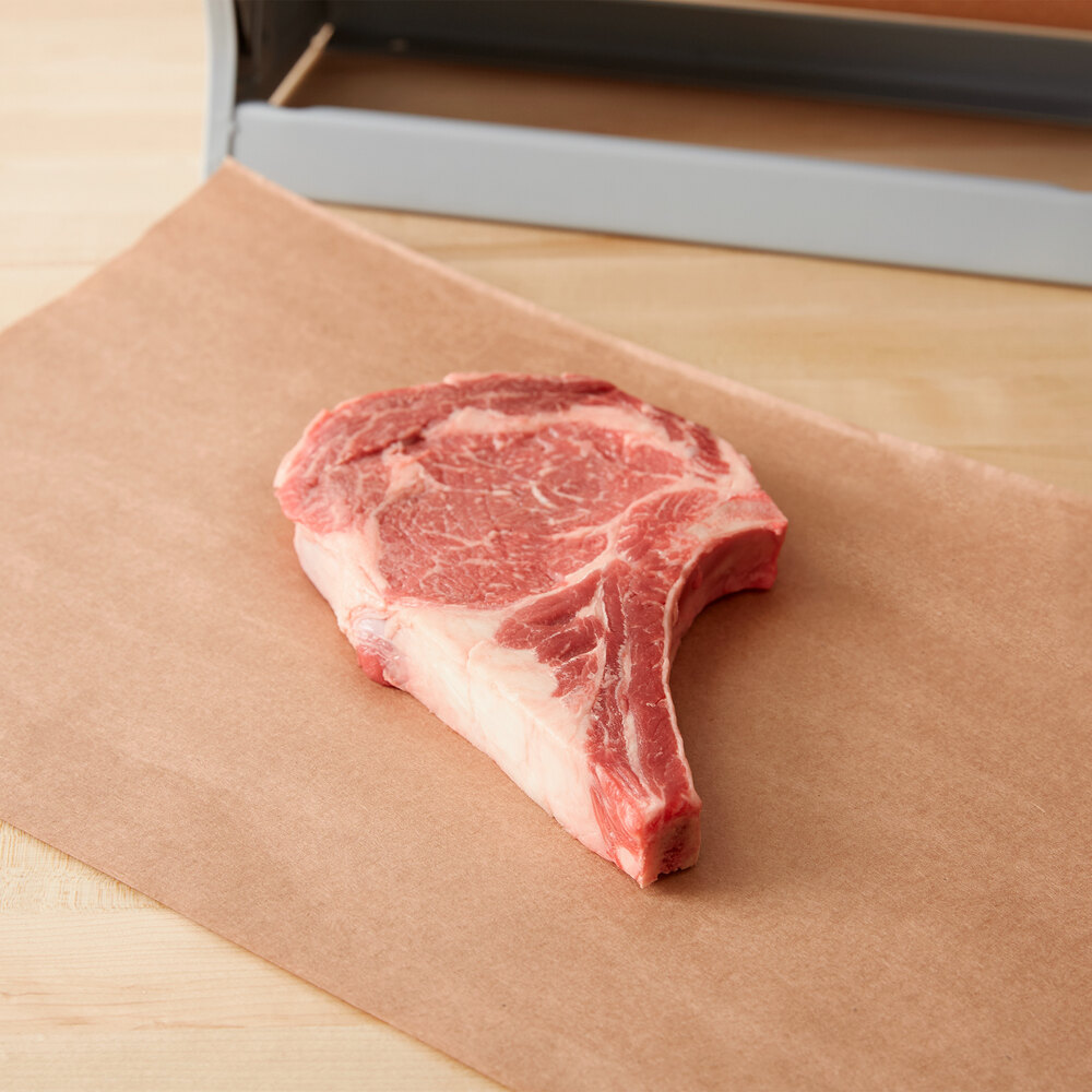 Brown butcher paper spread out with a cut of steak on top