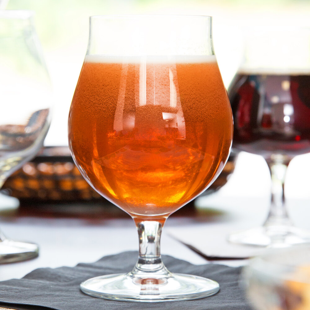 Tulip-shaped beer glass filled with amber beer