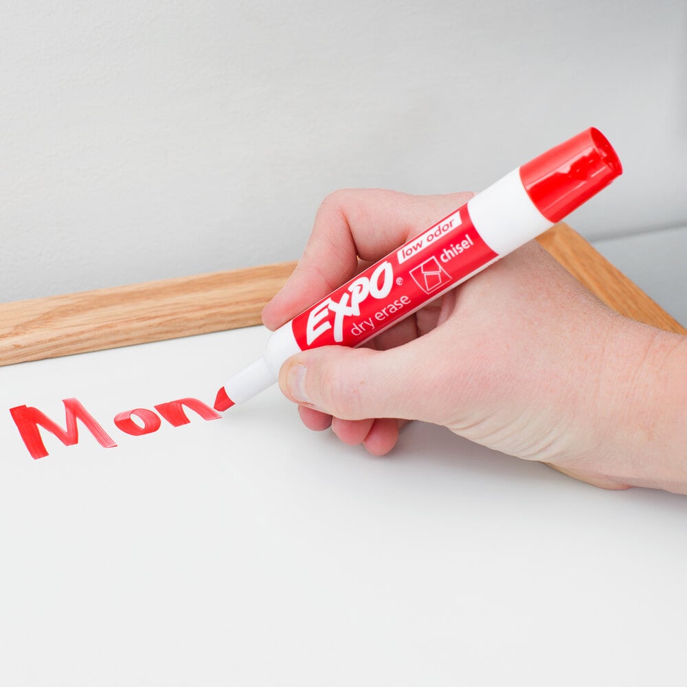 Person writing on a whiteboard with an Expo red dry erase marker