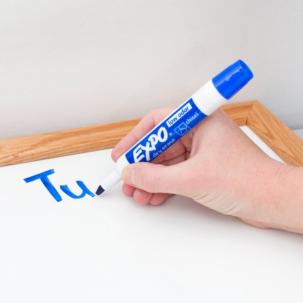 Person writing on white erase board with blue Expo large tip marker