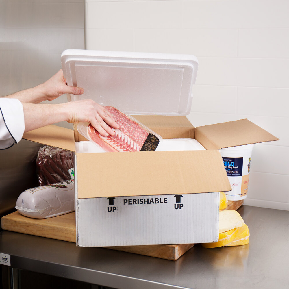 Hand placing meat in insulated shipping container